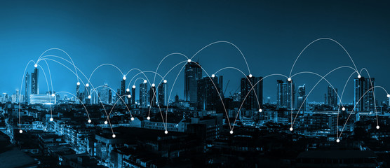 digital technology network connection concept over the city with blue tone night city scape...