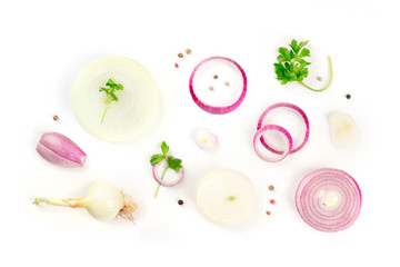 Red and white onions, shallots, parsley leaves and peppercorns, shot from the top on a white background