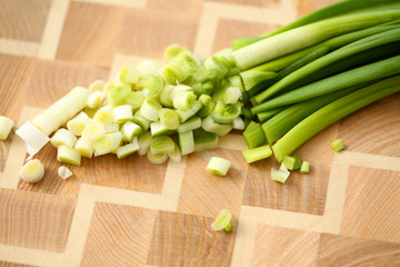 Cook holds knife in hand and cuts on cutting