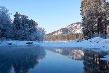 Blue Lake in the Mountain Valley of the Katun River, Chemale region. The Republic of the Mountain Altai. winter view of the lake in the mountains. fantastic nature. Winter fairy landscape.