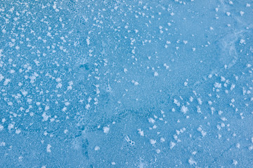 Fototapeta premium Beautiful texture abstraction ice with flowers from ice and snow blue color