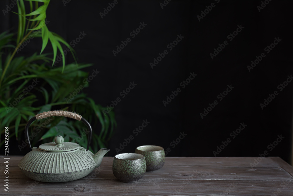 Sticker teapot and teacups on black background