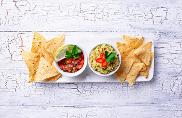 Guacamole, tomato sauce salsa and chips nachos