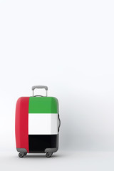 Travel suitcase with the flag of UAE. Holiday destination. 3D Render