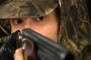 eyes of a hunter aiming with a shotgun