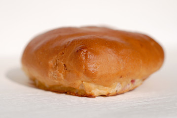 Freshly baked patty on a light background closeup. Shallow depth of field