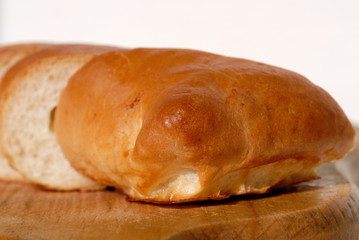Fresh pie cut into pieces on a wooden board closeup. Shallow depth of field