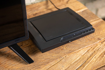 Compact DVD player in a vintage interior on a TV nightstand