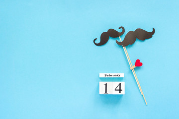 Couple paper mustache props fastened clothespin heart and calendar February 14 on blue background. Concept Homosexuality gay love. Valentine's Day Top view Copy space Template for text or design