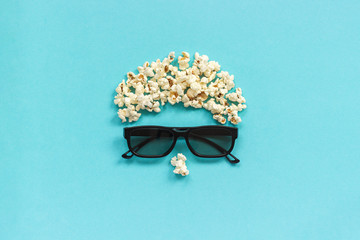 Abstract image of viewer, 3D glasses and popcorn on blue background. Concept cinema movie and entertainment Flat lay Top view