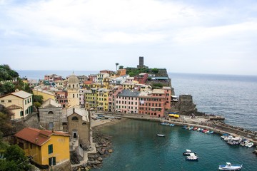 Fototapeta na wymiar Beautiful small town of Vernazza in the Cinque Terre national Park. View on Vernazza Castello Doria the old fortress and tower at the coastal hill of town Vernazza. Italian colorful landscapes.