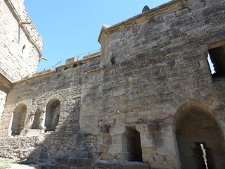 The stone walls of the ancient city of Carcassonne, a UNESCO heritage site, in France, on a clear Sunny day.