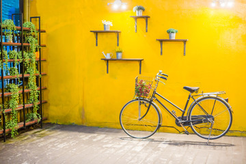 Fototapeta na wymiar Vintage bicycle on vintage yellow wall