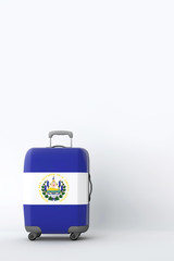 Travel suitcase with the flag of El Salvador. Holiday destination. 3D Render