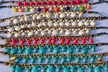 Colorful bracelets for sale on street at night market, Thailand. Souvenirs for tourists at market , close up