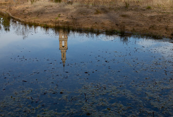 Universidad Laboral de Gijón is reflected on a puddle