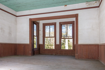 Alcove in vintage abandoned farmhouse with wood wainscoting