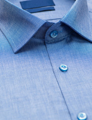 blue shirt with a focus on the collar and button, close-up