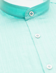 green shirt with a focus on the collar and button, close-up