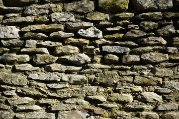 Natural stone wall lovingly bricked or misplaced photographed in a park in Germany 