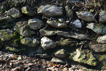 Natural stone wall lovingly bricked or misplaced photographed in a park in Germany 