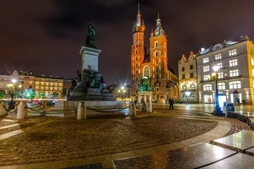 Deurstickers Adam Mickiewicz Monument on Main Market Square in front of  St. Mary's Basilica  in Krakow, Poland at night © Ruslan