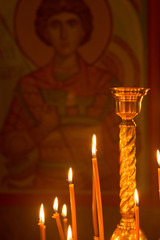 Candles are burning, stand in the church candlestick. Temple.