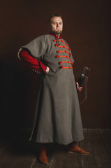 Portrait of a man in a medieval costume on a dark background. Clothes of the Polish gentry.