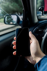 Closeup on hand holding smartphone for assistance, car communication gps navigation system...