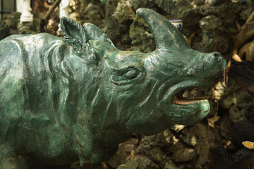 Fototapeta na wymiar the old concrete statue of a rhinoceros