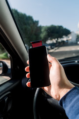 Closeup on hand holding smartphone for assistance, car communication gps navigation system...