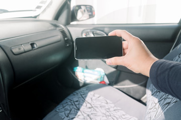 Closeup on hand holding smartphone for assistance, car communication gps navigation system...