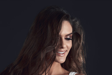 Portrait of a girl in a studio on a black background.