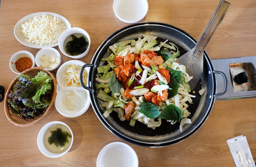 Korean food consists of chicken, vegetables and chili paste.