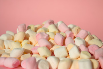 Marshmallows on pink background with copyspace. Flat lay or top view with boke on background.