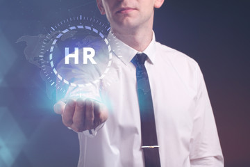 The concept of business, technology, the Internet and the network. A young entrepreneur working on a virtual screen of the future and sees the inscription: HR