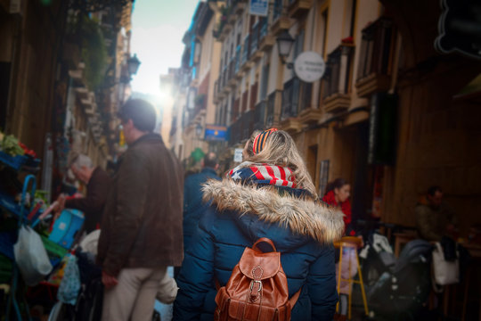 Woman Walking Trough A Market And Restaurants In San Sebastian. Pinchos And Tapas Food.