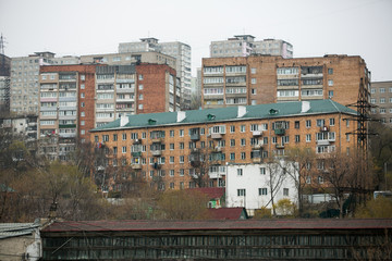 Fototapeta na wymiar Residential development of Vladivostok panel and brick houses. Streets of sleeping areas of the capital of the Far East