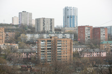 Fototapeta na wymiar Residential development of Vladivostok panel and brick houses. Streets of sleeping areas of the capital of the Far East