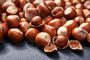 Hazelnut   on black table , selective focus