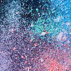 Colorful background of chalk powder. Multicolored dust particles splattered on black background.