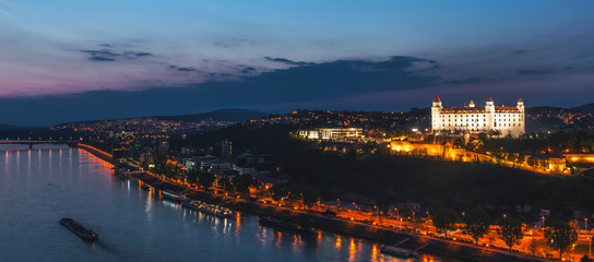 Naklejka premium Beautiful panorama of Bratislava Downtown.View of town during the sunset.Cityscape at twilight.Traveling concept background.The landscape of the old city.Architecture, buildings Slovakia Europe