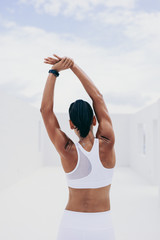 Fitness woman doing workout stretching her arms and back