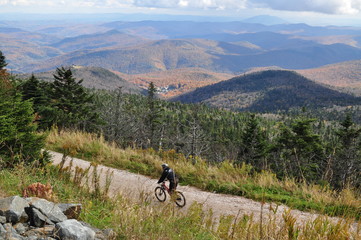 Fototapeta na wymiar Mountain Biking in the Fall Down a Mountain in Vermont