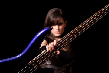 Obraz na płótnie Canvas Young Rocker Woman Holding Bass Guitar - Rock Musician Guitarist
