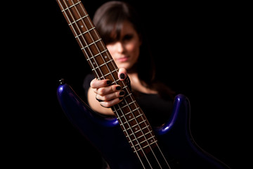 Fototapeta premium Young Rocker Woman Holding Bass Guitar - Rock Musician Guitarist