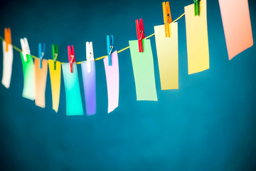 Colorful cards hung on a rope with colorful clasps