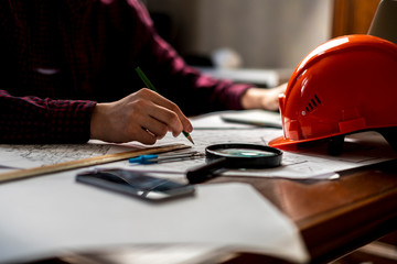 male worker sign documents with helmet on a table b