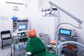 Dentist's office, oral hygiene, dental instruments close-up. The medical office is equipped with an armchair and special lighting for dental treatment.