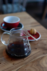 Bruch chemex coffeemaker cup of coffee. Black espresso, wooden texture background table